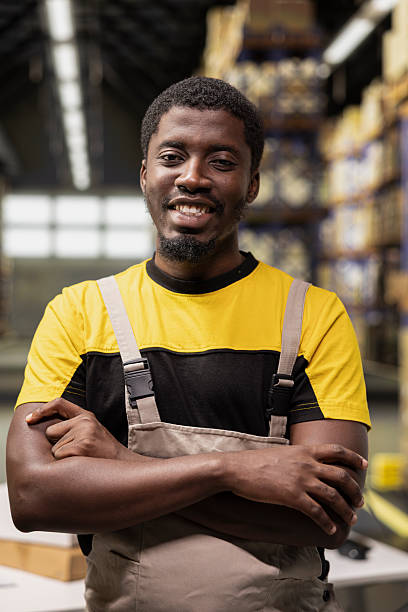 istock Portrait of confident smiling guy working in a modern warehouse 2252441793
