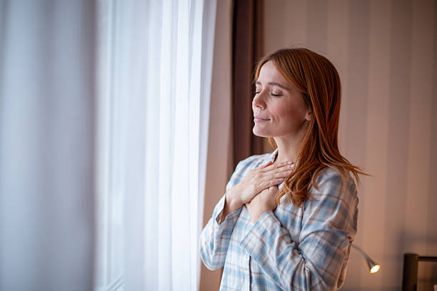 istock Woman feeling peaceful meditating with hands on chest 2252445206