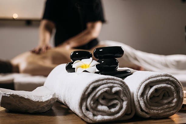 istock Relaxing spa setting featuring smooth black stones, a white towel 2252445448