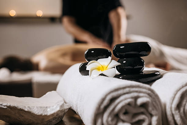 istock Relaxing spa setting featuring smooth black stones, a white towel 2252445450