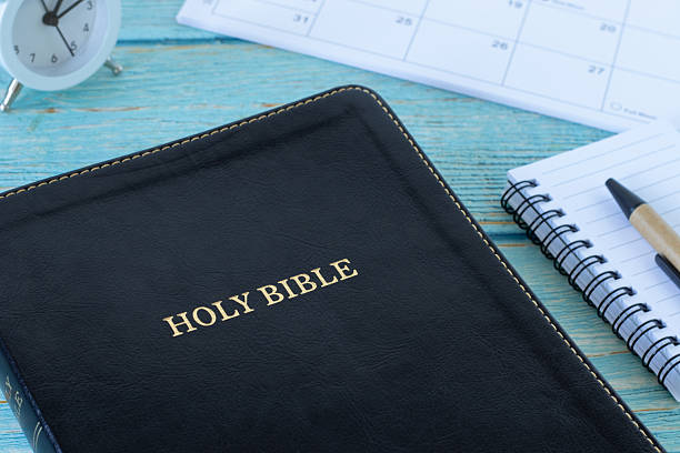 istock Holy bible book with notebook, calendar, and alarm clock 2252449089