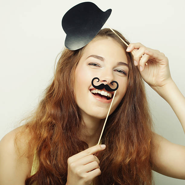Young asian woman in witch Halloween costume with gesture of ok or confirm isolated on orange background. October