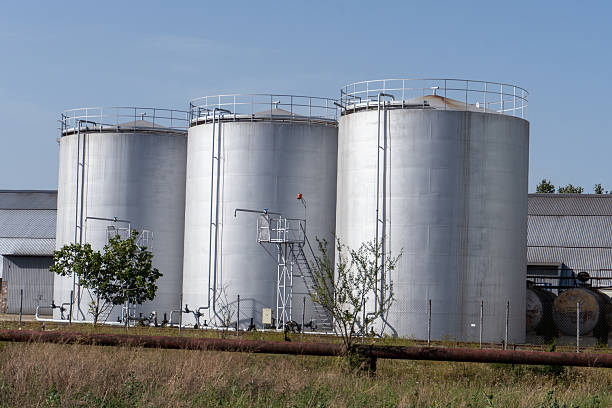 istock Three large tanks are in a field 2252450374
