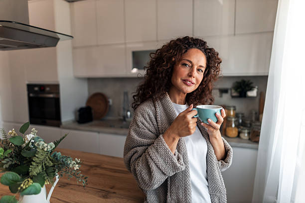 istock Cozy Morning Woman In Kitchen With Coffee Mug Wearing Plush Robe 2252451921