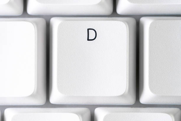 Clean macro texture of a keycap with the letter D on a white keyboard