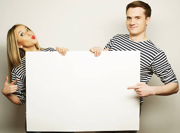 istock Couple holding a banner 2252453545