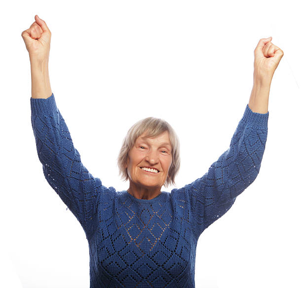 istock senior woman gesturing victory over white background 2252454818