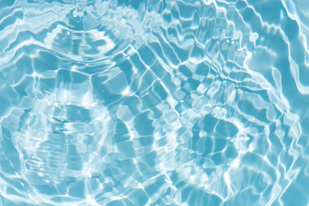 istock Bluewater waves on the surface ripples blurred. Defocus blurred transparent blue colored clear calm water surface texture with splash and bubbles. Water waves with shining pattern texture background. 2252464972