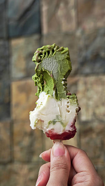 Matcha strawberry ice cream, served on a stick.
