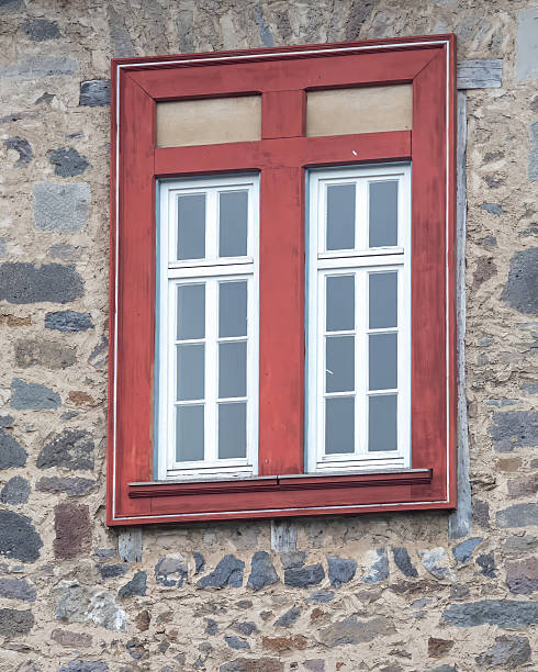 istock Charming red window on a stone wall in a historic building captures rustic character and architectural details in a quaint setting 2252470075