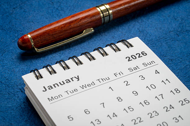 istock January 2026 - small spiral desktop calendar with a pen, time an 2252477308