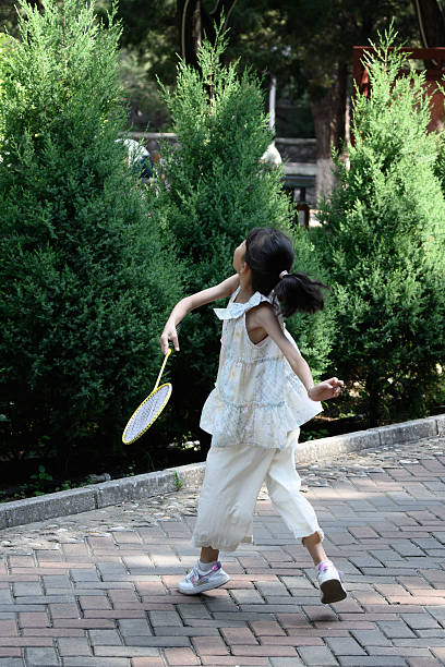 Asian girl wielding a badminton racket