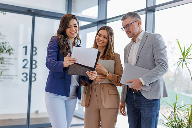 istock Business colleagues collaborating on project in modern office with documents 2252483862