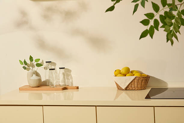 istock Glass bottles, lemons, and a basket arranged under leafy shadows. Clean and neutral styling, homemade juices, citrus benefits,. Blank space for text or packaging 2252485047