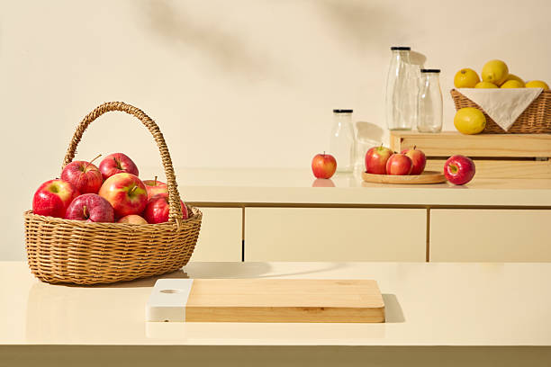 istock A rustic wicker basket of apples next to a cutting board on beige kitchen surface. Minimal setup evoke homely cooking, apple juice, natural extracts, and wholesome lifestyle imagery 2252485053