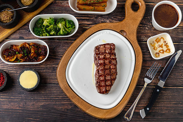 istock Thick grilled beef steak served on a rustic wooden board 2252487391