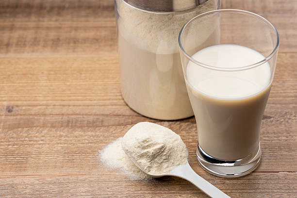 istock Protein Shake Poured into Glass with Measuring Spoon 2252488298