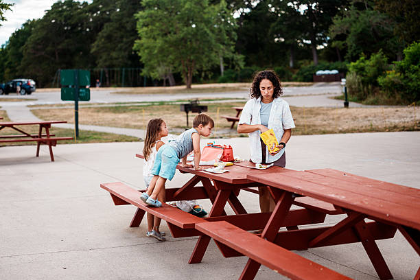 istock Mom with Kids Preparing Picnic Lunch 2252491513