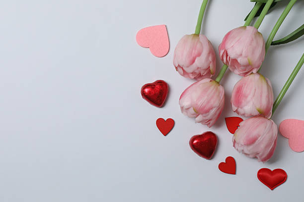 istock Pink tulips, gift box and hearts on a color background 2252491668