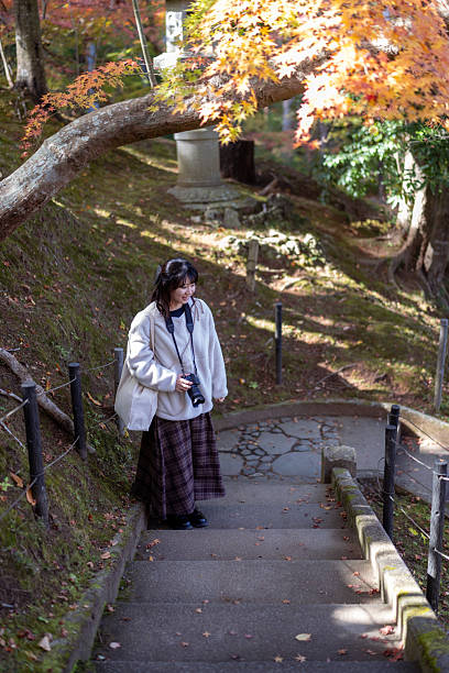 Young female tourist looking at view from steps in public park