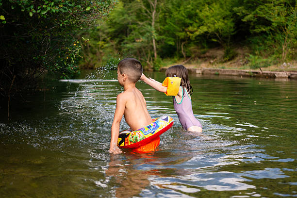 istock Kids splashing playing in river during summer holidays 2252496732