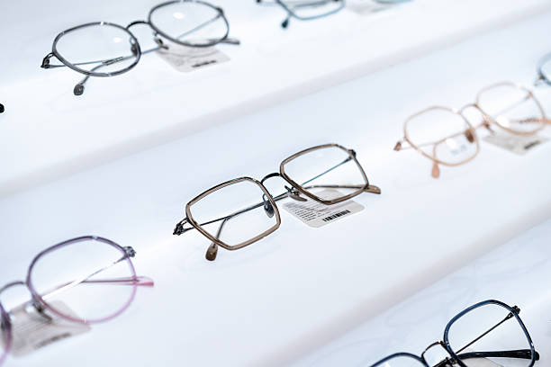 istock Stylish modern eyeglass frames displayed on a white, brightly lit shelf in an optical store. 2252496737