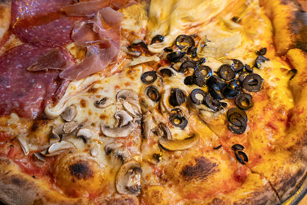 Close-up of artisanal sourdough pizza with salami, prosciutto, m