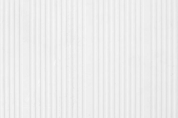 istock Table top high angle view of old textured gray white colored grayscale striped grooved corrugated full frame cardboard or paperboard, packaging material, packing for shipping, or tin roof, rooftop, or fence wall 2252497114