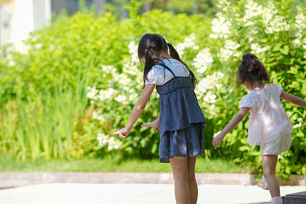 Children playing catch in a grass garden