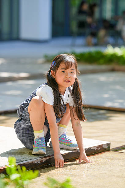 istock A young girl is crouching down in a park 2252497611