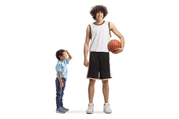 happy handsome student holding a basketball isolated over white background.