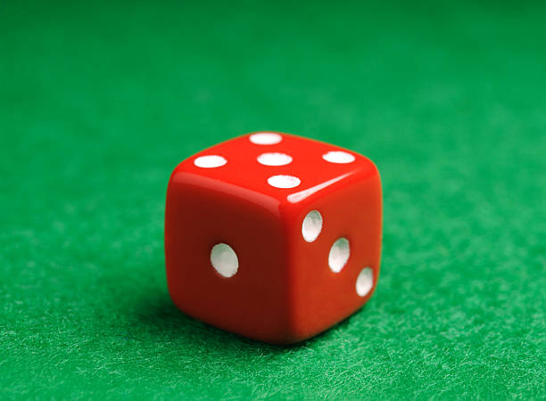 istock Red gambling dice on black background 2252502472