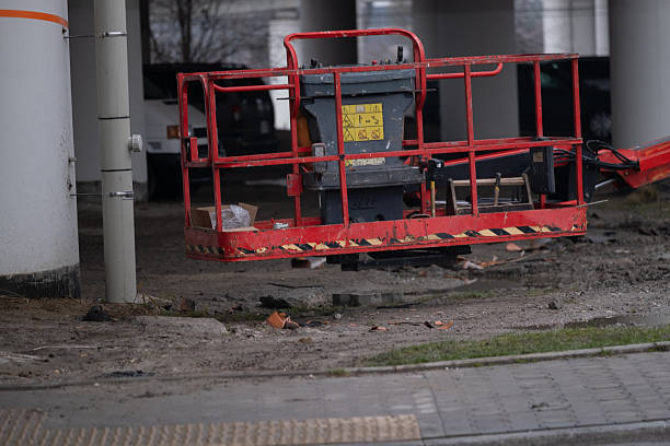 istock Red construction lift platform parked at building site 2252502561