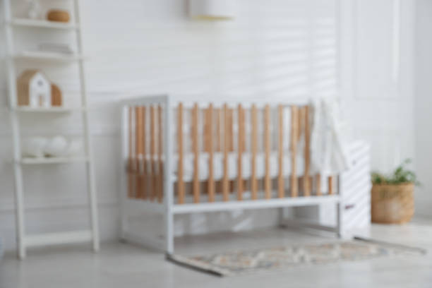 Blurred view of baby's room with stylish crib