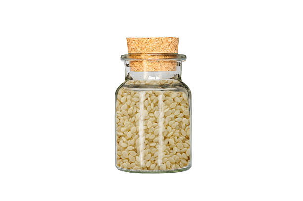 istock sesame in glass container isolated on white background 2252505703