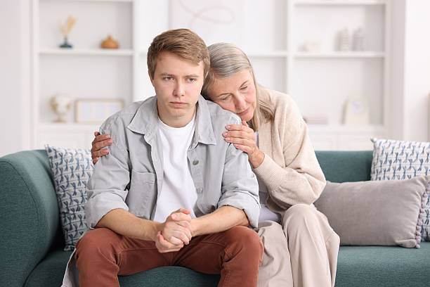 istock Mother supporting her son on sofa at home 2252507301