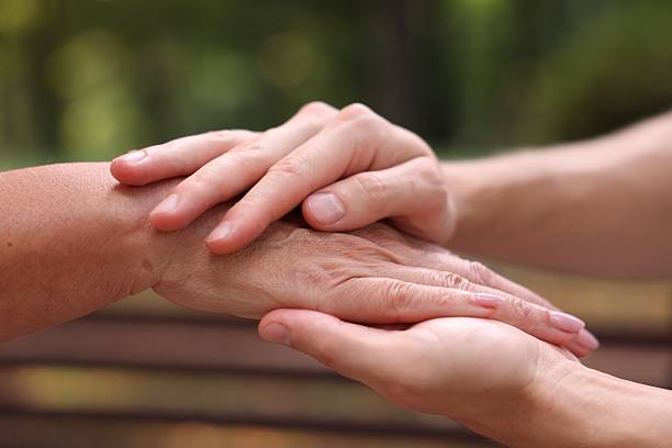 istock Son and his mother holding hands outdoors, closeup 2252507506