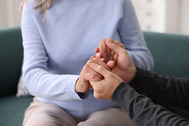istock Son and his mother holding hands indoors, closeup 2252507802