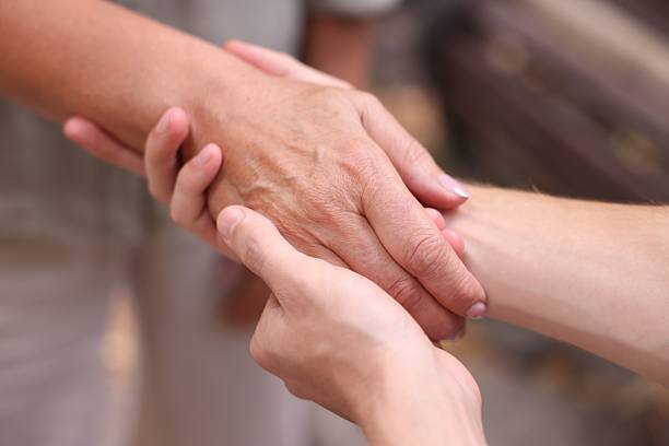 istock Son and his mother holding hands outdoors, closeup 2252507842