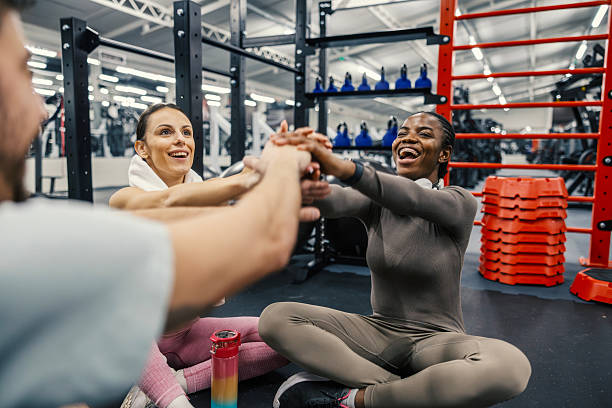 istock Diverse fitness team stacking hands showing teamwork in gym 2252507914