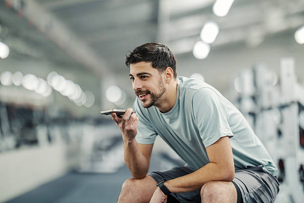 istock Young man using smartphone voice message during gym workout 2252508177