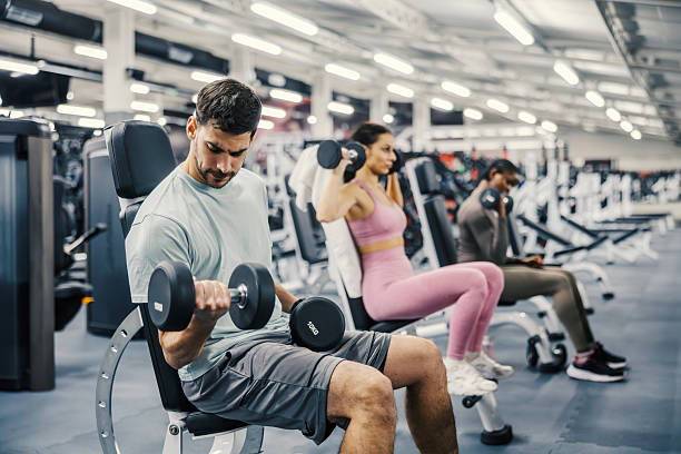 istock People training with dumbbells in modern gym 2252508502