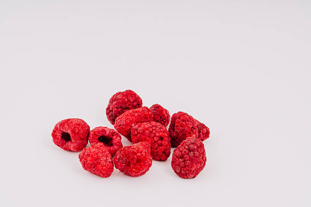istock Freeze-dried raspberries scattered on a clean white surface, showcasing their vibrant red color and unique texture, perfect for healthy snacks, baking, or adding to smoothies and desserts with copy space 2252509894