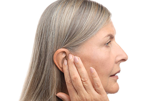 istock Sound. Senior woman touching her ear on white background 2252510677