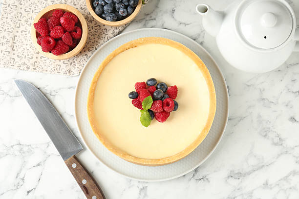 istock Delicious cheesecake with fresh berries served on white marble table, flat lay 2252511563