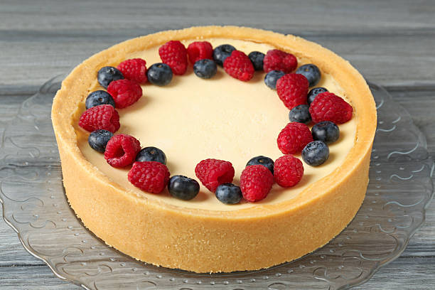 Delicious cheesecake with fresh berries on grey wooden table, closeup
