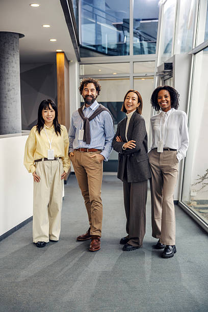 istock Diverse business team smiling in modern office hallway 2252513631