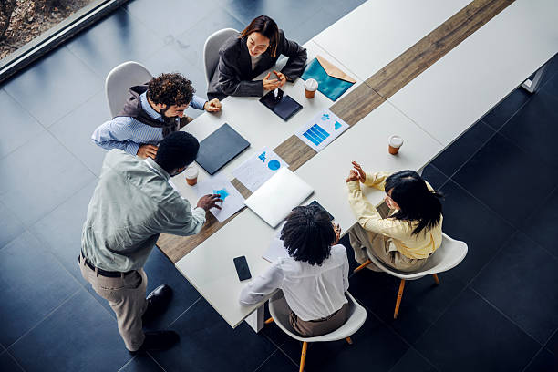 istock Business team collaborating during office meeting, overhead view 2252513764