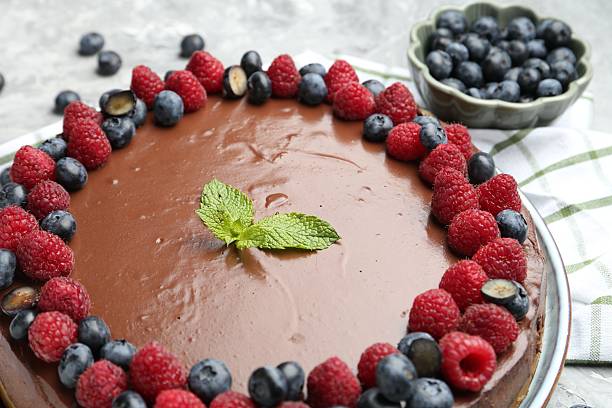 istock Delicious chocolate cheesecake with berries and mint on table, closeup 2252517185
