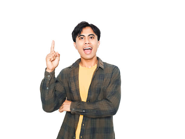 istock Young asian man pointing up and showing good idea gesture, isolated on white background. Concept of creativity, inspiration, solution, and advertising message. 2252522833